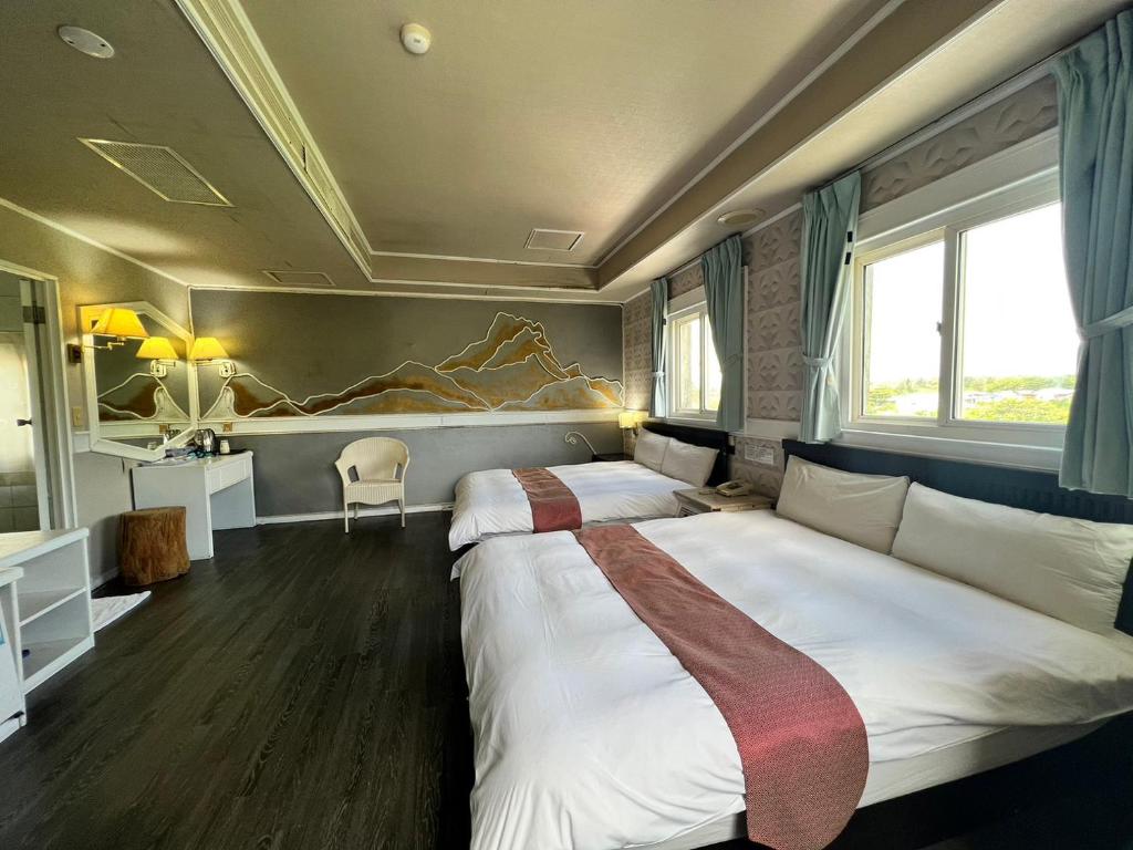 Postel nebo postele na pokoji v ubytování Dajenshan Hotel
