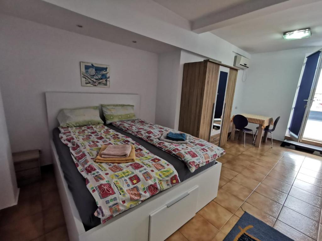 a bedroom with a bed with a quilt on it at Fitness House with garden in Constanţa