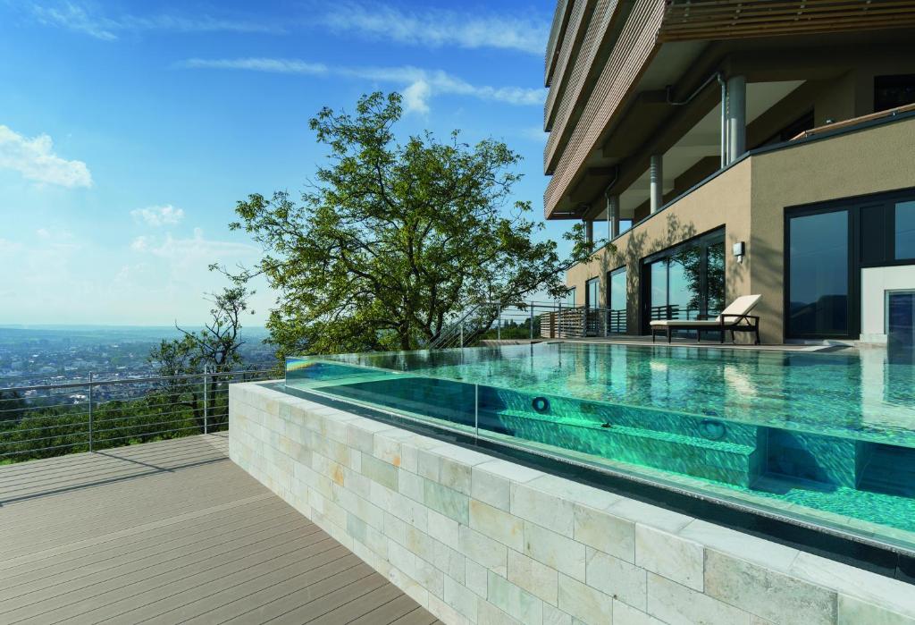 a swimming pool on the side of a house at Achalm Hotel in Reutlingen