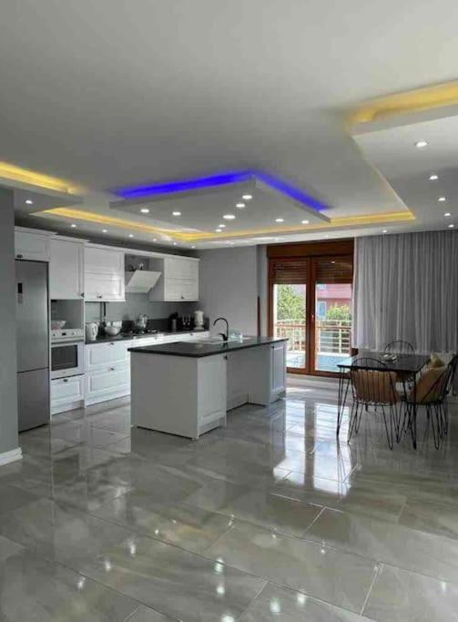 a large kitchen with a table and chairs in it at The Luxe Esenköy Villa in Yalova