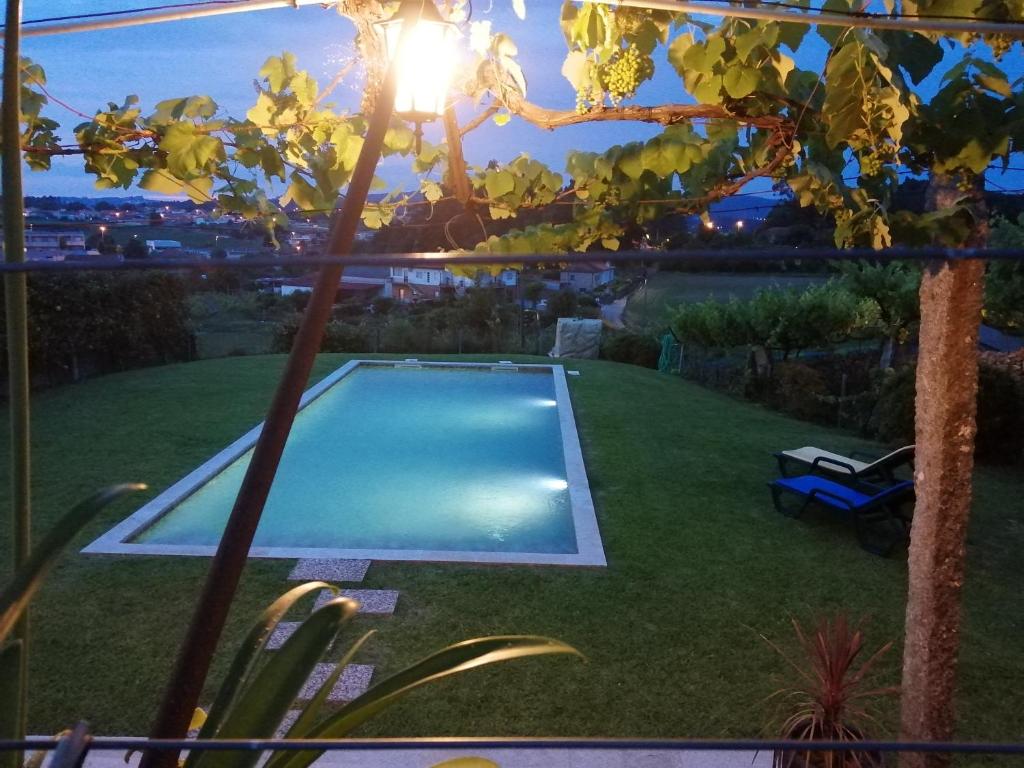 a backyard with a swimming pool in the yard at Casa de São Braz in Landim