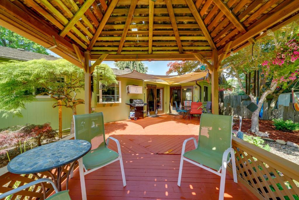 a patio with a table and chairs on a wooden deck at Vancouver Vacation Rental about 16 Mi to Portland! in Vancouver