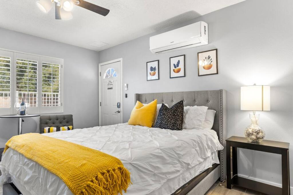 a bedroom with a bed with a yellow blanket on it at CHARMING STUDIO OVERLOOKING THE POOL. in Phoenix
