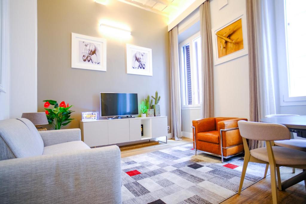 a living room with a couch and a tv at Dolcevita Boutique Apartment in Florence