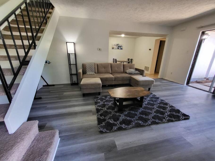 a living room with a couch and a table at Sweet Home IN in Indianapolis