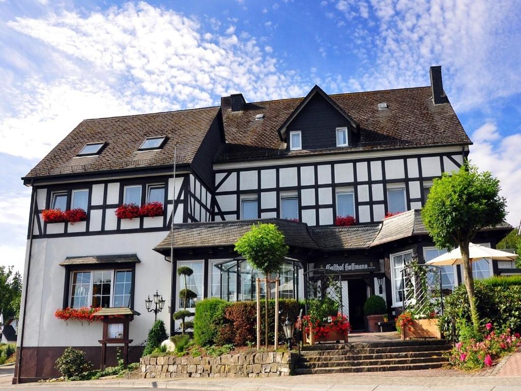 a large black and white house with at Landgasthof Hoffmann GbR in Arnsberg