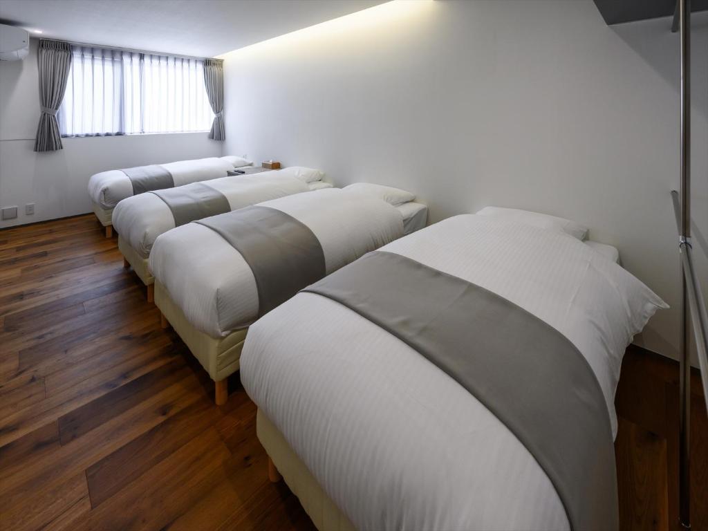 Postel nebo postele na pokoji v ubytování Onna Resort 海まで徒歩0秒 最大12名宿泊可 オーシャンビュー貸切ヴィラ