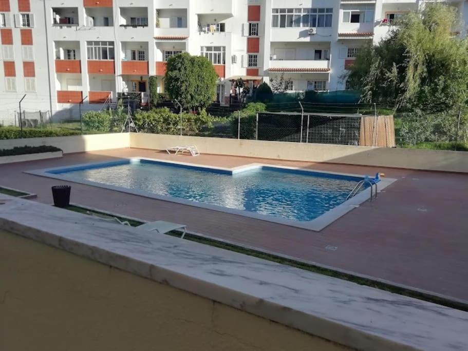 a swimming pool in the middle of a building at Happydreams apartment in Albufeira in Albufeira