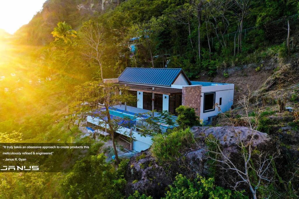 an aerial view of a house on a hill at Enclave Villa V3 -Overlooking Pitons & Ocean ! Wow in Soufrière