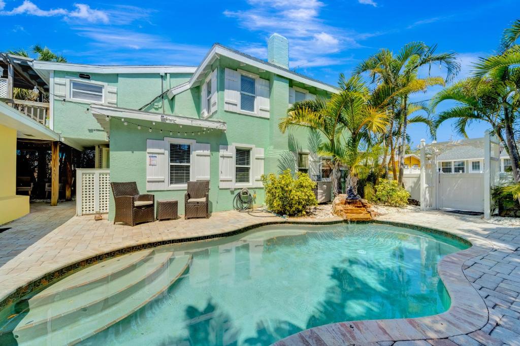 a house with a swimming pool in front of a house at Casa Del Sol C in Bradenton Beach