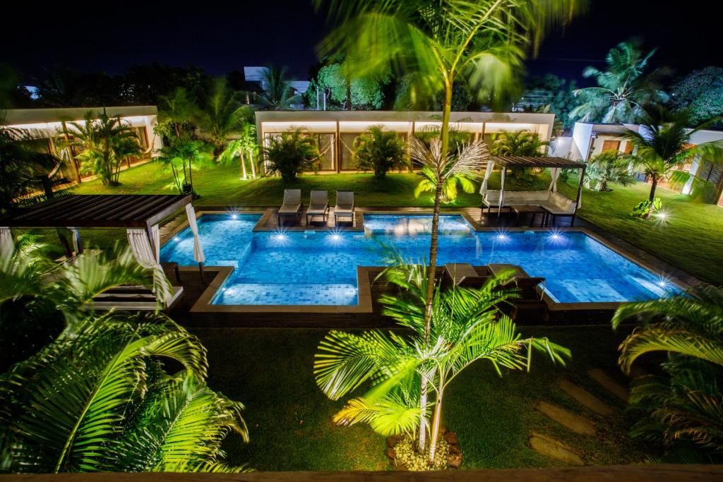 an image of a swimming pool at night at Portofino Pousada in São Miguel do Gostoso