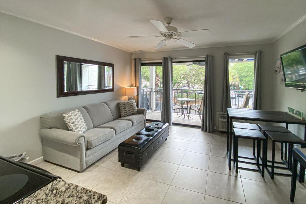 a living room with a couch and a table at Sea Side Villas 108 in Hilton Head Island