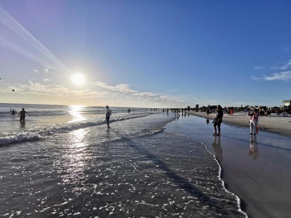 a group of people walking on the beach at Luxury 3BD house, Siesta Key Beach in Sarasota