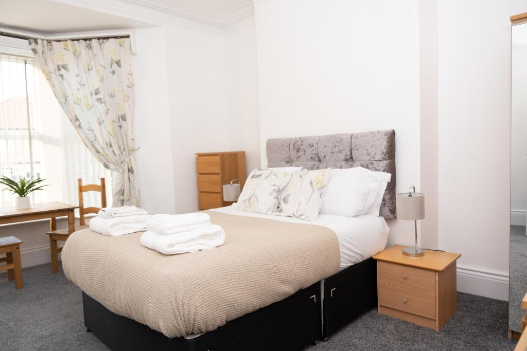a bedroom with a bed with white towels on it at Shortridge Terrace - 1 in Jesmond