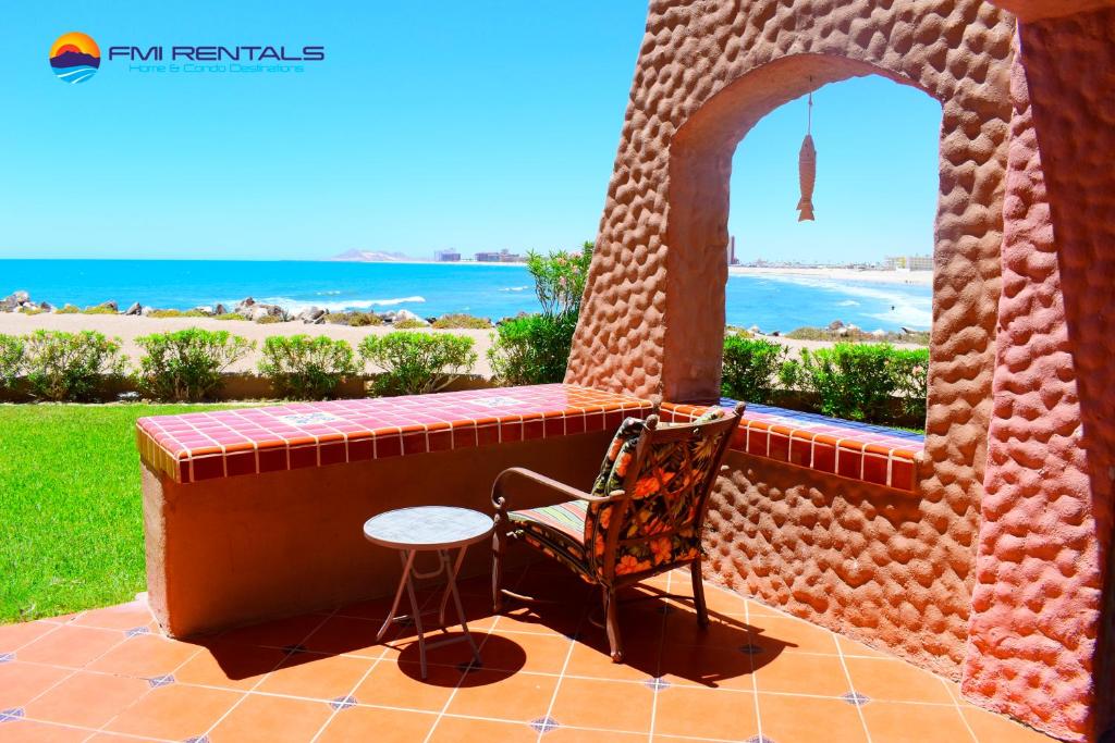 a chair sitting on a patio with a view of the ocean at Marina Pinacate B-101 in Puerto Peñasco