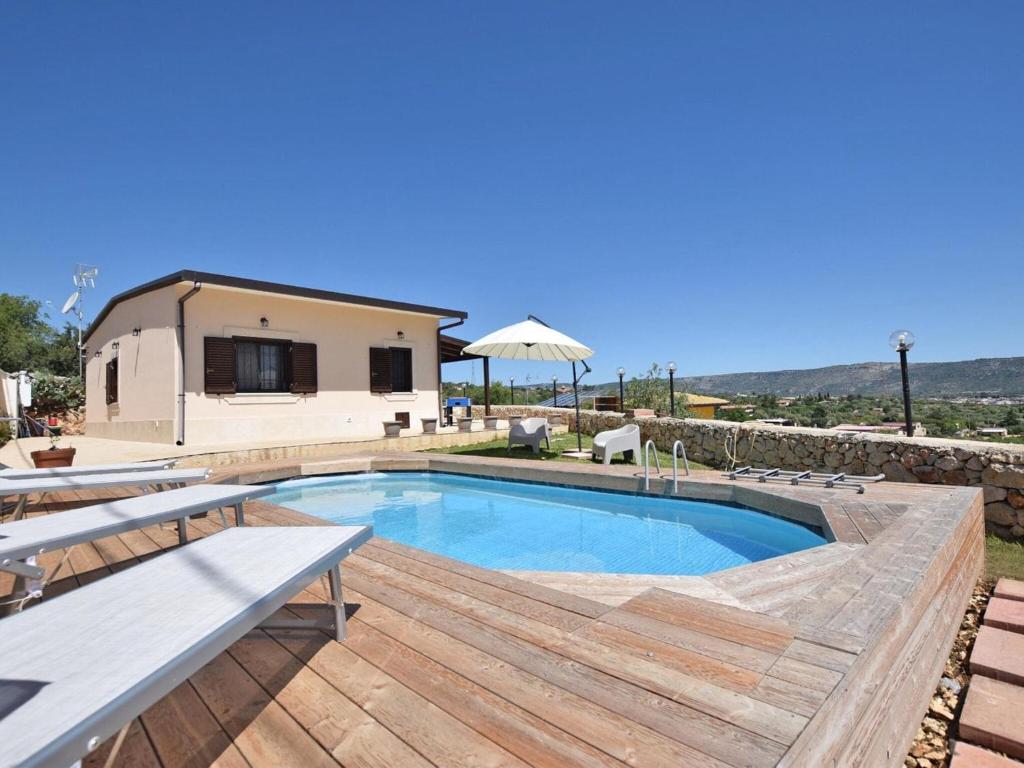 a villa with a swimming pool and a house at Holiday Home Floridia with Private Pool in Floridia