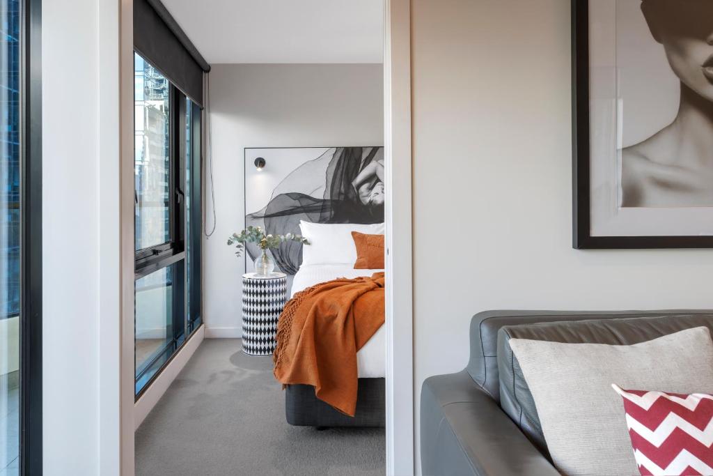 a bedroom with a bed and a window at Imagine Southbank in Melbourne
