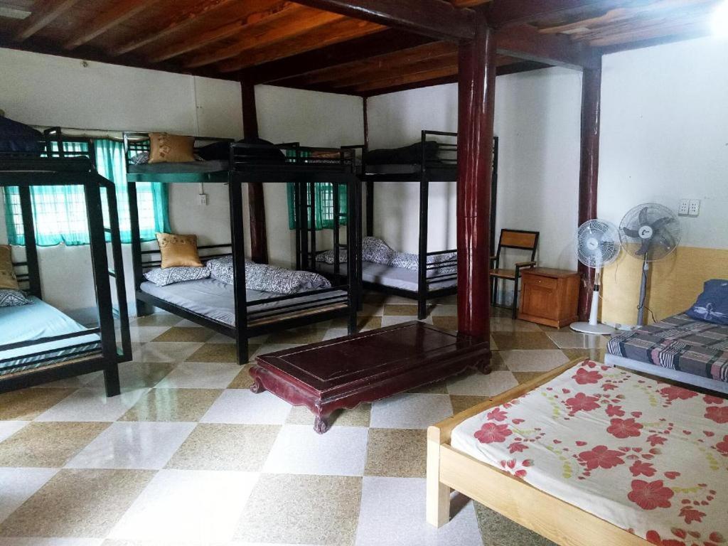 a room with four bunk beds in a room at Homstay Sinh thái Cây Sung Mộc Châu in Mộc Châu