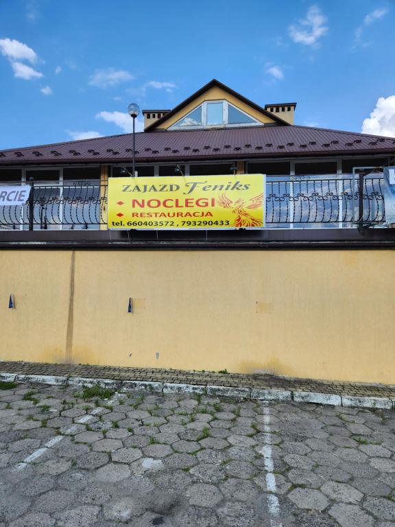 un edificio con una pancarta a un lado. en Zajazd FENIKS en Lubaczów