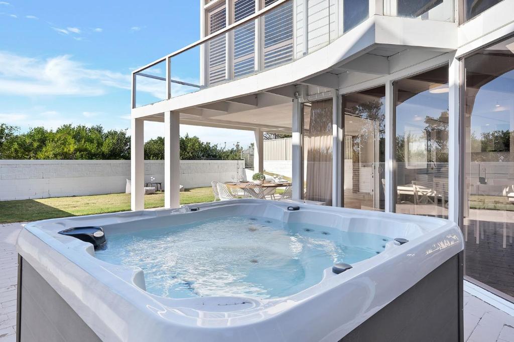 a hot tub in the backyard of a house at Ubuntu by Experience Jervis Bay in Vincentia