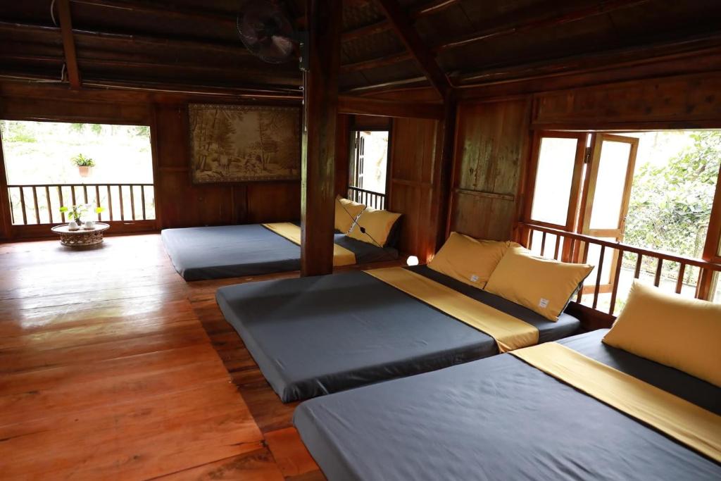 a room with three beds on a porch at 6Senses Garden Homestay in Hòa Bình