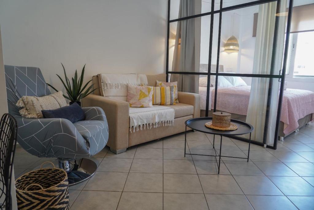 a living room with a couch and a table at Jelinas bright apartment in the centre of Nafplio in Nafplio