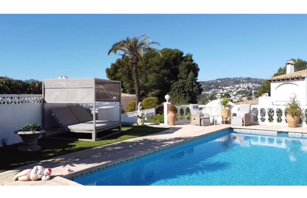 a swimming pool in front of a house at Casa Maya in Benissa