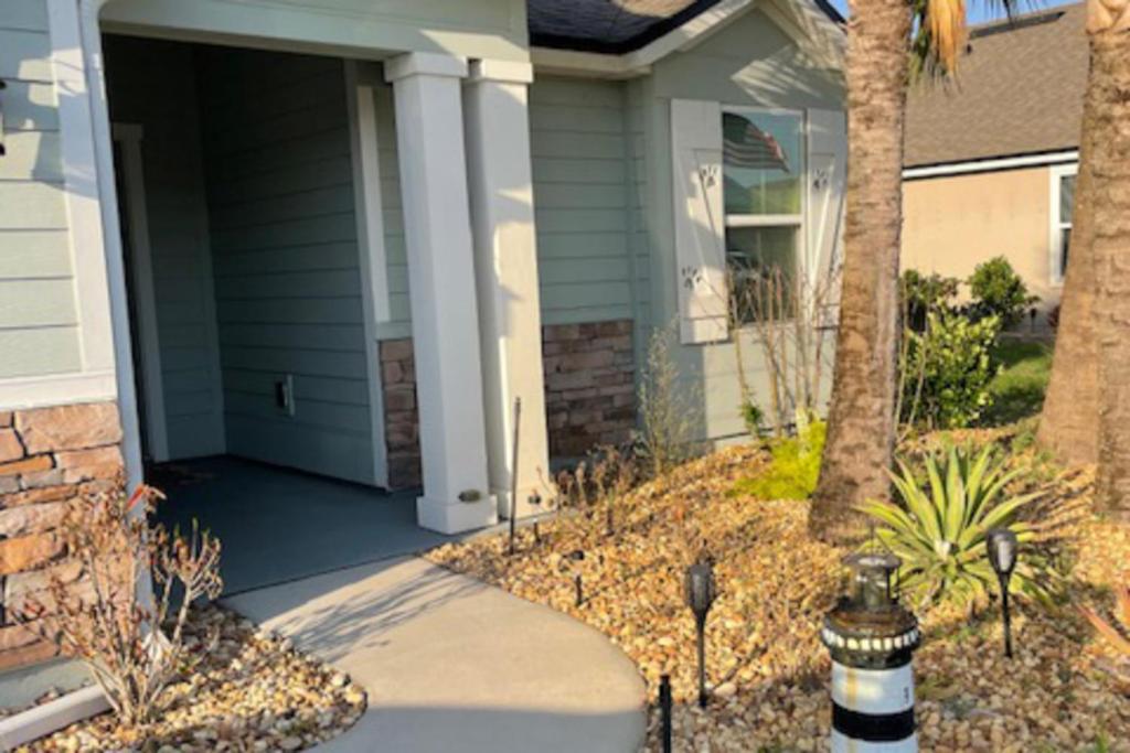 a house with a driveway with a fire hydrant in front of it at Serenity by the Sea in Saint Augustine