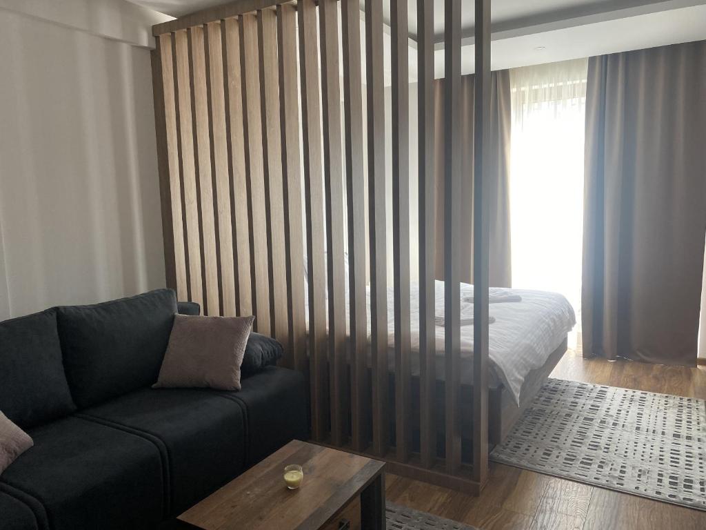 a living room with a couch and a bed at VortexLux in Kopaonik
