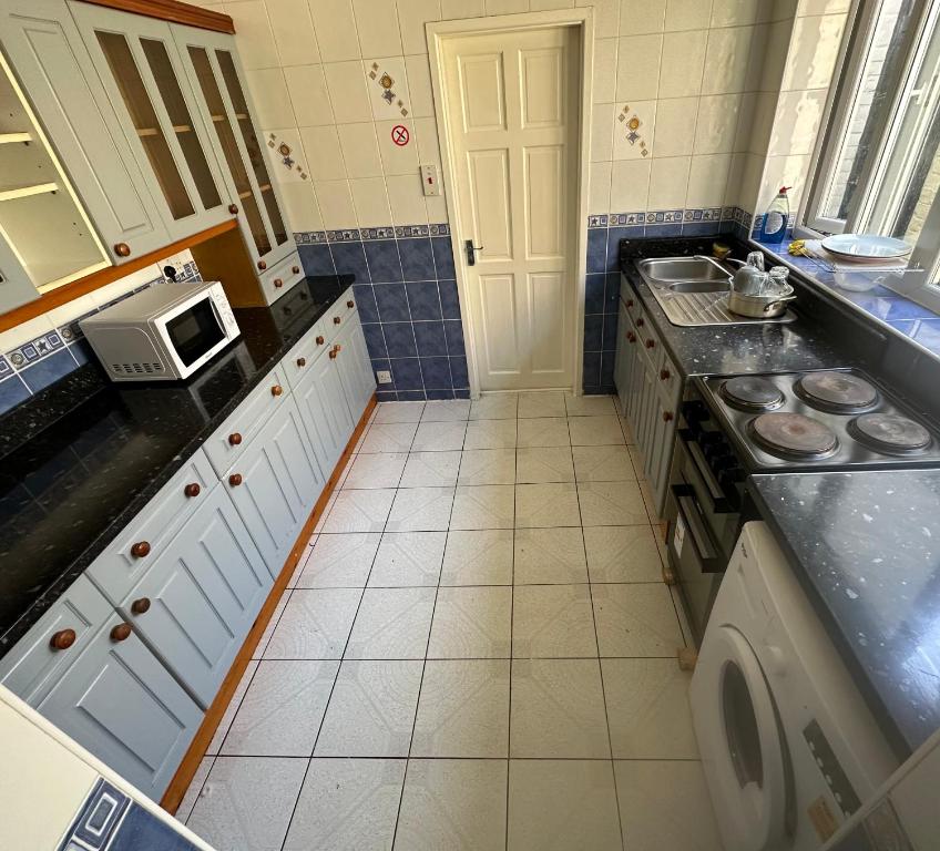 a small kitchen with a sink and a microwave at Clifton Street in Middlesbrough