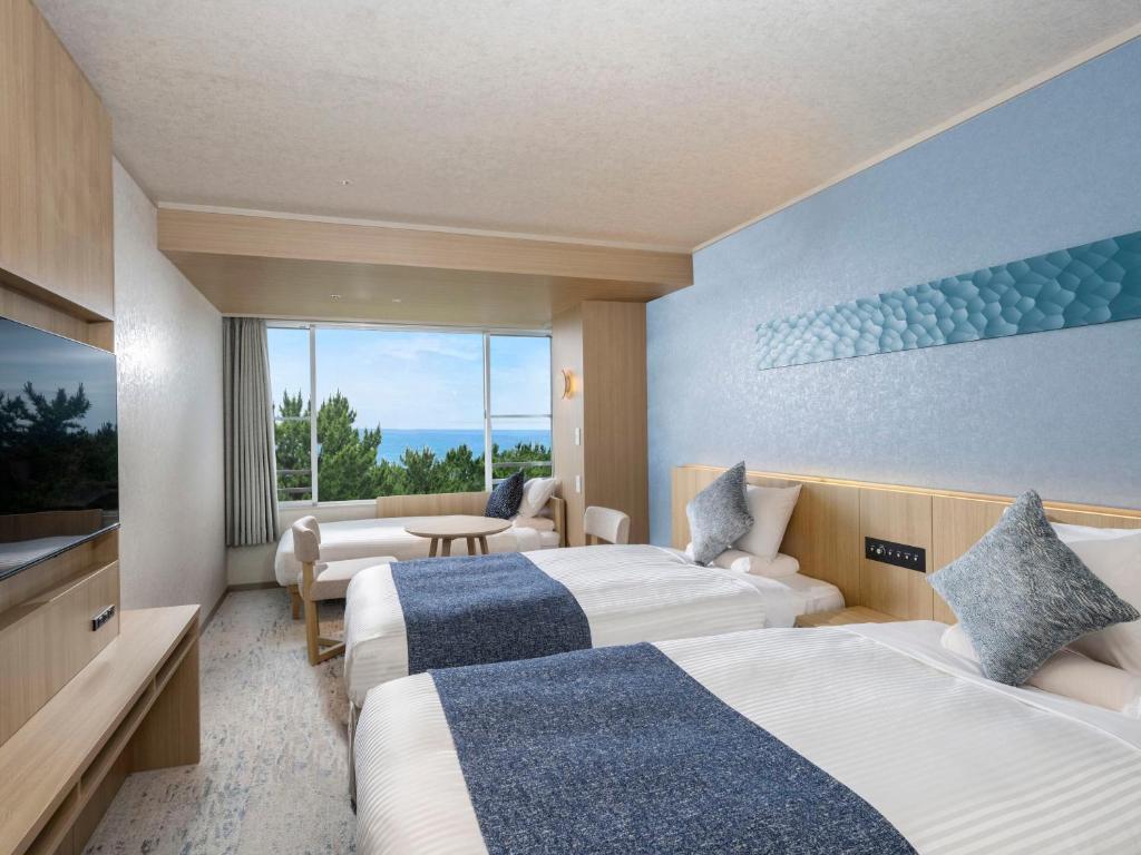 Postel nebo postele na pokoji v ubytování KAMENOI HOTEL Kamogawa