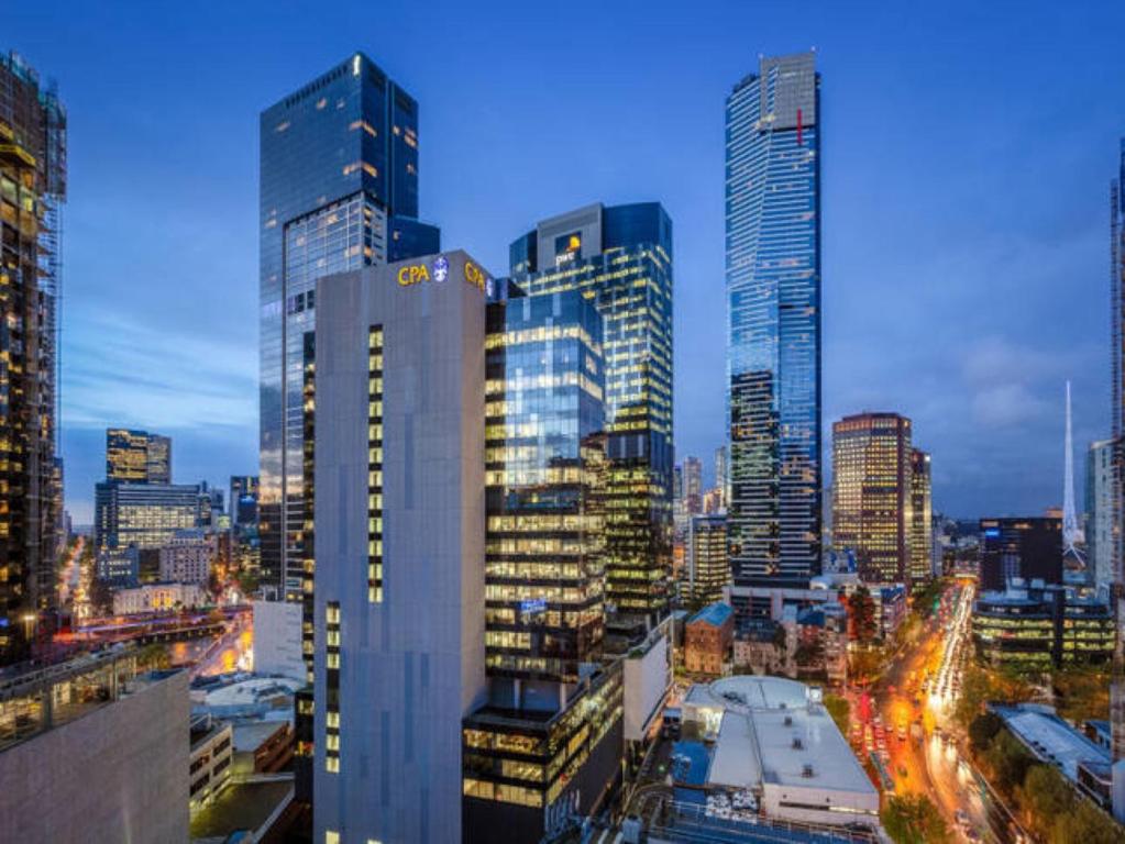 a city skyline at night with tall buildings at StayCentral - Cityviews on City Road Southbank in Melbourne