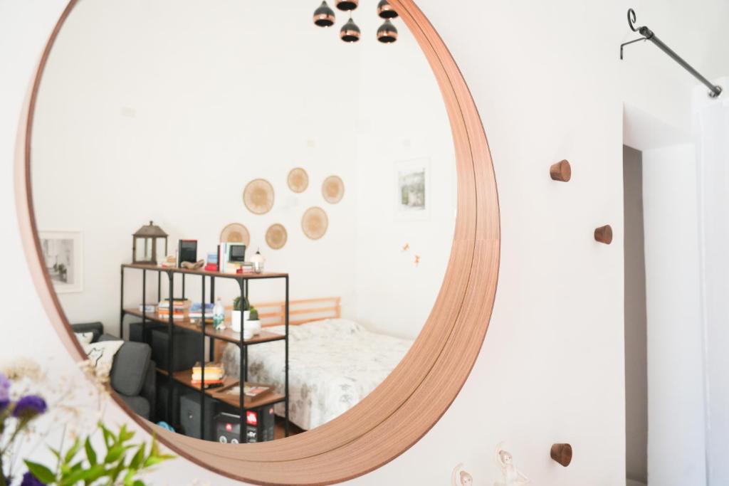 a large round mirror in a room with a bed at Casa San Cosimo in Massafra