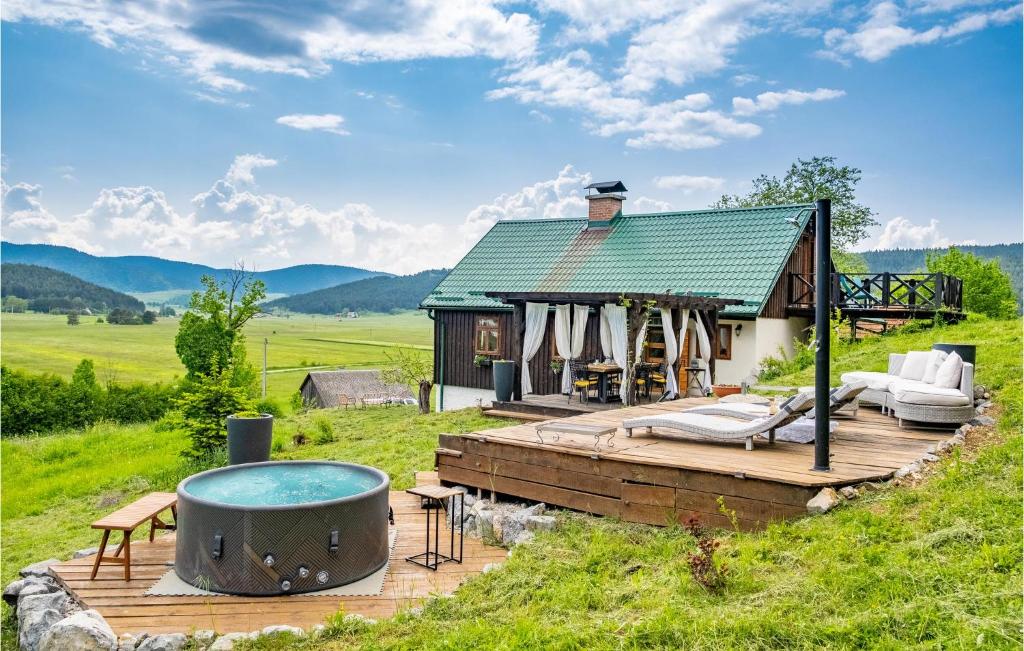 a small house with a hot tub on a deck at Amazing Home In Donji Babin Potok With Jacuzzi in Donji Babin Potok