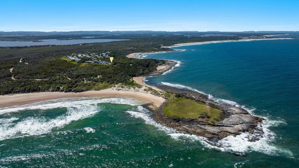 an aerial view of a beach and the ocean at The Point Ultimate Beach House in Yamba