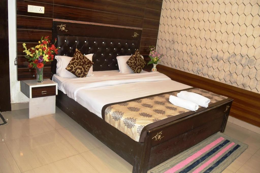 a bedroom with a large bed with a wooden headboard at Hotel Udika Palace in Kaohni