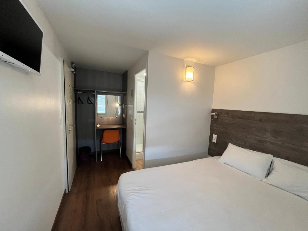 ムイユロン・ル・カティフにあるファストホテル ラ ロシュ シュル ヨンのベッドルーム1室(大きな白いベッド1台付)、廊下が備わります。