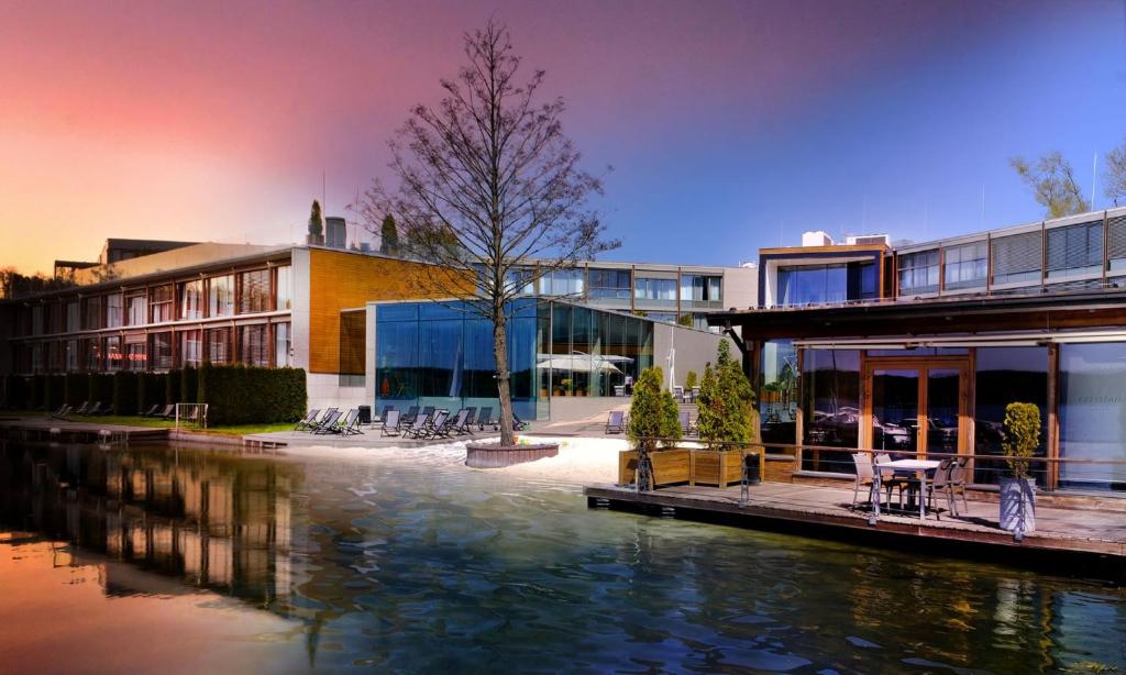 a group of buildings next to a body of water at Przystań Hotel&Spa in Olsztyn