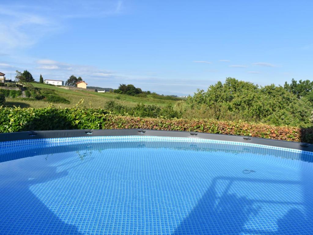 a swimming pool with a view of a field at Espectacular villa con vistas al mar, in Mogro