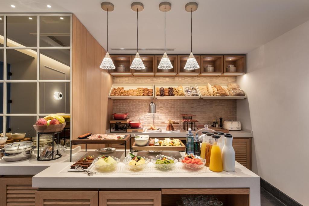 a kitchen with a bunch of food on a counter at Áurea Casa Palacio Sagasta by Eurostars Hotel Company in Cádiz