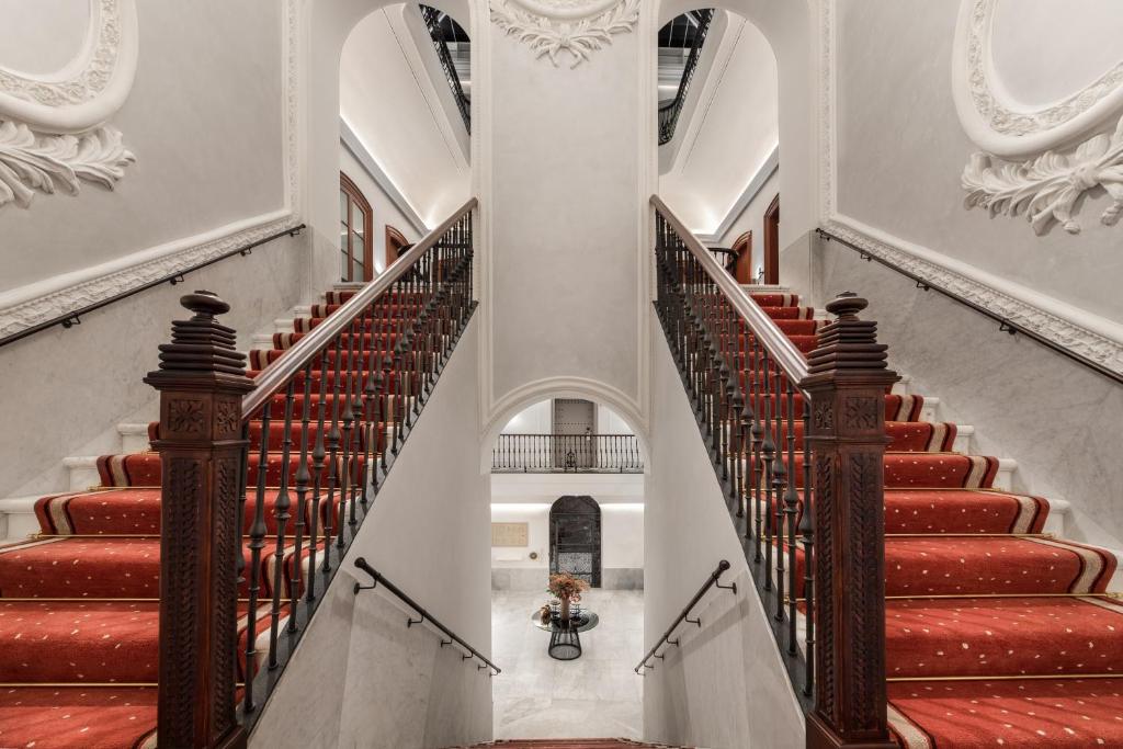 an image of a staircase in a building with red carpeted stairs at Áurea Casa Palacio Sagasta by Eurostars Hotel Company in Cádiz