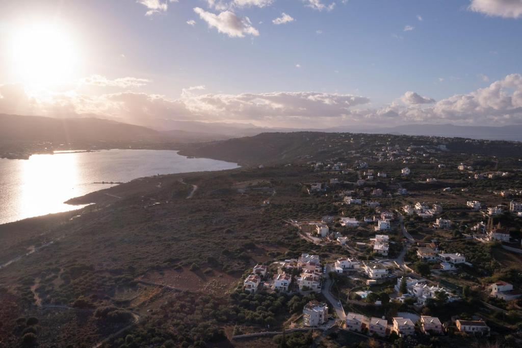 an aerial view of a town next to a body of water at Jarko Luxury Houses in Argoulidhés