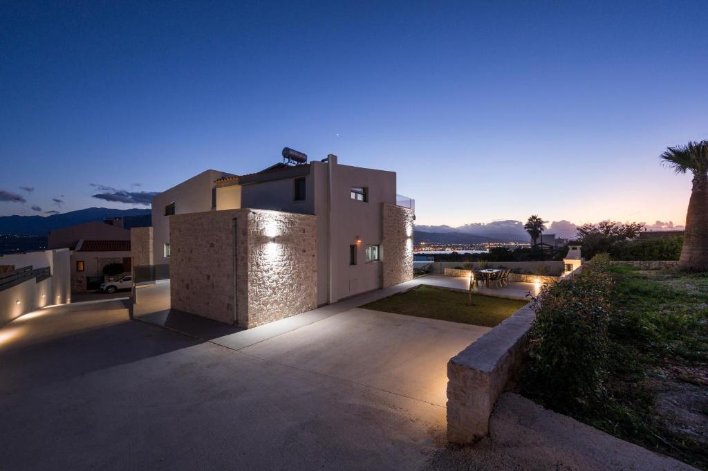 a house with lights on the side of it at Jarko Luxury Houses in Argoulidhés