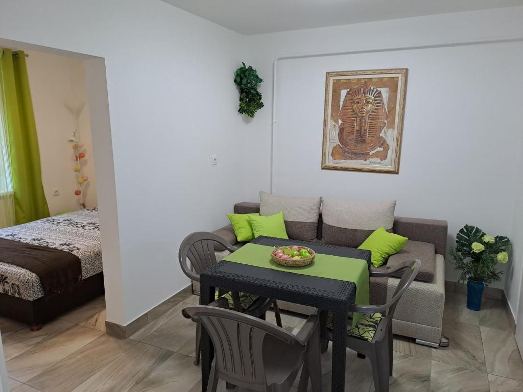 a small living room with a table and a couch at Sweet Summer Apartman Zsory in Mezőkövesd