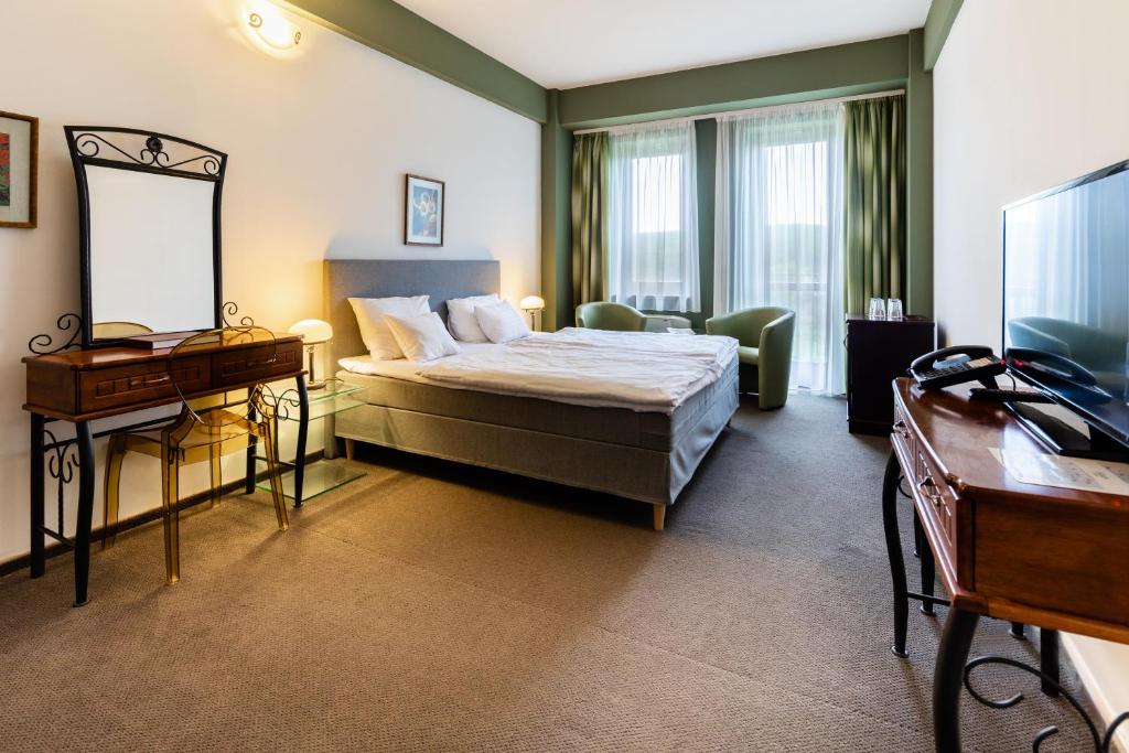 Postel nebo postele na pokoji v ubytování Hotel Vécsecity