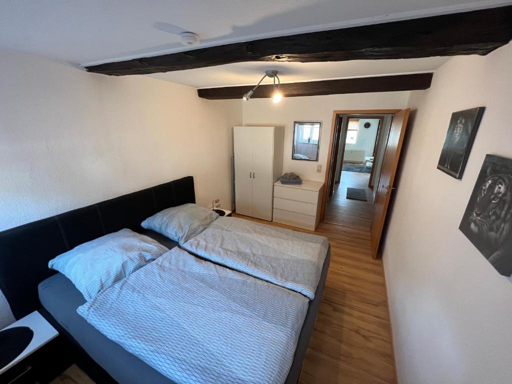 a small bedroom with a bed and a hallway at Ferienwohnung Weser 3 in Holzminden