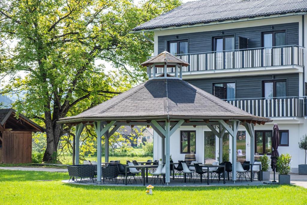 a gazebo in front of a house at Hotel Fuchs & Hase SELF CHECK IN in Rosegg