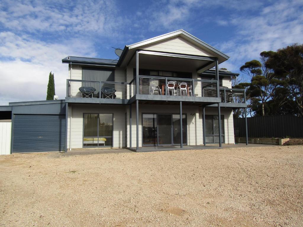 a house with a balcony with chairs on it at Lady Doris in Port Vincent