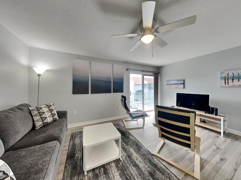 a living room with a couch and a ceiling fan at Madeira Beach Yacht Club 261f in St. Pete Beach