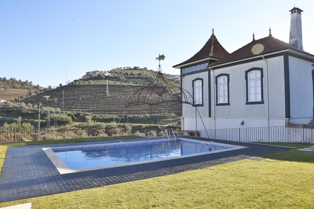 a house with a swimming pool in the yard at Casa de Cambres in Lamego